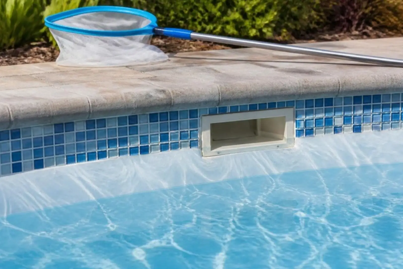 Pool waterline tile and skimmer after cleaning